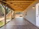 Covered patio area under a wooden deck with brick flooring, offering an outdoor living space at 6145 Stargazer Way, Cumming, GA 30028