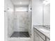 Modern bathroom shower featuring marble-look tile walls, a black herringbone-patterned floor, and a glass door and window at 6145 Stargazer Way, Cumming, GA 30028