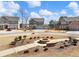 Community street view with fire pit and well-maintained lawns at 6145 Stargazer Way, Cumming, GA 30028