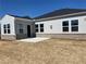 View of the home's exterior and backyard with a concrete patio, showing the home's siding and brick foundation at 670 Pineberry Dr, Grayson, GA 30017