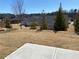 Exterior view of the backyard with trees and landscaping, as seen from the concrete patio at 670 Pineberry Dr, Grayson, GA 30017