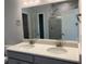 Bathroom featuring double sink vanity with quartz countertop and modern finishes with marble-look shower tile at 670 Pineberry Dr, Grayson, GA 30017