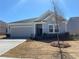 Charming single-story home with a gray exterior, well-manicured lawn, and a two-car garage at 670 Pineberry Dr, Grayson, GA 30017