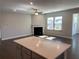 Open floor plan showcasing the kitchen island and fireplace in the living room at 670 Pineberry Dr, Grayson, GA 30017