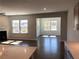 Bright and airy living space with multiple windows and an open transition to a sunroom or dining area at 670 Pineberry Dr, Grayson, GA 30017