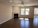 Bright living room featuring a fireplace, dark wood floors, recessed lighting and several large windows at 670 Pineberry Dr, Grayson, GA 30017