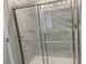 A shower with clear glass doors and marble-look tile on the walls and shower floor at 670 Pineberry Dr, Grayson, GA 30017