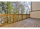 Outdoor balcony with wooden decking and railing, surrounded by lush trees and greenery at 1047 Brandsford Nw St, Atlanta, GA 30318