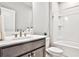 Clean bathroom featuring a dark vanity, a white sink, and a combined shower and tub with white tiling at 1047 Brandsford Nw St, Atlanta, GA 30318