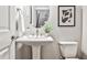 Charming half-bathroom featuring a pedestal sink, sleek fixtures, and modern decor at 1047 Brandsford Nw St, Atlanta, GA 30318