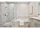 Modern bathroom featuring a soaking tub and a glass-enclosed shower with neutral colored tile surround at 1047 Brandsford Nw St, Atlanta, GA 30318