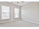 Spacious bedroom featuring neutral carpet, a ceiling fan, and large windows offering exterior views at 1047 Brandsford Nw St, Atlanta, GA 30318