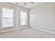 Bright bedroom featuring neutral carpeting, light grey walls, and two large windows, creating a calm atmosphere at 1047 Brandsford Nw St, Atlanta, GA 30318