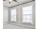 Bright bedroom featuring neutral carpeting, light grey walls, and two large windows, creating a calm atmosphere at 1047 Brandsford Nw St, Atlanta, GA 30318