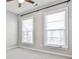 Bright bedroom with neutral carpet, a ceiling fan, and two large windows for ample natural light at 1047 Brandsford Nw St, Atlanta, GA 30318