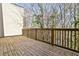 Large wooden deck with wood railings and a view of the trees at 1047 Brandsford Nw St, Atlanta, GA 30318