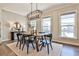 Bright dining area features modern lighting, a wooden table, and backyard views at 1047 Brandsford Nw St, Atlanta, GA 30318