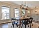 The dining area is illuminated by modern light fixtures and features three large windows at 1047 Brandsford Nw St, Atlanta, GA 30318