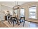 A dining room features an open layout, modern light fixtures, and bright natural light at 1047 Brandsford Nw St, Atlanta, GA 30318