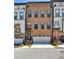Three-story brick townhome featuring a two-car garage and covered front entrance at 1047 Brandsford Nw St, Atlanta, GA 30318