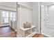 Hallway with a built-in bench and coat rack leading to a full bathroom and a cozy office area at 1047 Brandsford Nw St, Atlanta, GA 30318