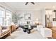 Bright living room features stylish furniture, a modern ceiling fan, and flows into the kitchen at 1047 Brandsford Nw St, Atlanta, GA 30318