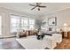 The sun-drenched living room features neutral tones, stylish furniture, and modern ceiling fan at 1047 Brandsford Nw St, Atlanta, GA 30318