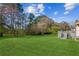 Expansive backyard with lawn, bordering trees and a deck at 1604 Quail Sw Run, Conyers, GA 30094