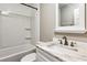 Bright bathroom featuring a tub shower and vanity with marble countertop and bronze-tone faucet at 1604 Quail Sw Run, Conyers, GA 30094