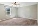 An empty room with a ceiling fan and a window at 1604 Quail Sw Run, Conyers, GA 30094