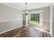 Cozy dining room with wood flooring, wainscoting, modern light fixture and a large window at 1604 Quail Sw Run, Conyers, GA 30094