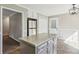 A kitchen featuring an island, stainless steel refrigerator, and a door to the outside at 1604 Quail Sw Run, Conyers, GA 30094