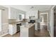 Well-lit kitchen with white cabinets, stainless steel appliances, and an island for added prep space at 1604 Quail Sw Run, Conyers, GA 30094