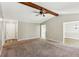 Open-concept living room with neutral walls, carpet flooring and a large doorway at 1604 Quail Sw Run, Conyers, GA 30094