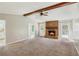 Inviting living room with a brick fireplace, exposed wood beams, and plenty of natural light at 1604 Quail Sw Run, Conyers, GA 30094