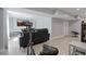 Spacious basement with an exercise bike, black leather sofa, and television, ideal for recreation and fitness at 3775 Lake Seminole Dr, Buford, GA 30519