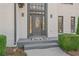 Elegant front door with sidelights and transom window, framed by manicured greenery at 3775 Lake Seminole Dr, Buford, GA 30519