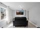 Modern living area featuring a black leather sofa, TV, and large window is perfect for relaxation and entertainment at 3775 Lake Seminole Dr, Buford, GA 30519