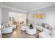 Bright living room featuring neutral-toned furnishings, crown molding, and hardwood floors at 3775 Lake Seminole Dr, Buford, GA 30519