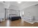 Large main bedroom featuring tray ceiling, a Bedroom area with crib and hardwood floors at 3775 Lake Seminole Dr, Buford, GA 30519