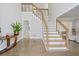 Open foyer featuring staircase with wooden handrail and stainless steel cables at 3775 Lake Seminole Dr, Buford, GA 30519