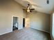 View of neutral bedroom with carpet, ceiling fan and en suite bathroom at 488 West Ave, Bowdon, GA 30108