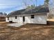 Exterior view of home with white siding, dark roof, and patio at 488 West Ave, Bowdon, GA 30108