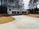 New home with a well-maintained lawn, modern design, and a concrete driveway at 488 West Ave, Bowdon, GA 30108