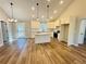 Open concept living and kitchen with hardwood floors and modern fixtures at 488 West Ave, Bowdon, GA 30108