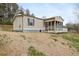 Side angle of tan manufactured home with screened porch and white railing deck at 718 Old Tennessee Ne Hwy, White, GA 30184