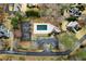 Aerial view showcases a pool, tennis court, and surrounding residences in a private community setting at 2883 Observation Nw Pt, Marietta, GA 30064