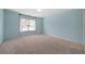 Spacious bedroom with plush carpet, a large window, and neutral paint at 2883 Observation Nw Pt, Marietta, GA 30064
