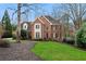 Charming brick two-story home featuring manicured lawn and mature trees at 2883 Observation Nw Pt, Marietta, GA 30064