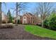 Well-maintained brick home with mature landscaping and a manicured lawn at 2883 Observation Nw Pt, Marietta, GA 30064